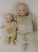 2 Armand Marseille bisque head dolls with cloth bodies height 32cm and 29cm