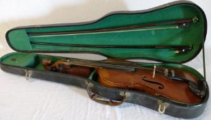 Two-piece back violin with a carved lions head terminal, 2 bows and a hard case