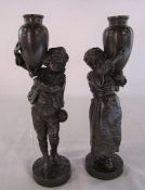 Pair of bronze effect figures of a boy and a girl carrying urns/pitchers H 27 cm