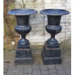 Pair of cast iron garden urns on bases H 110cm