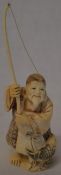 Meiji period carved ivory okimono of a fisherman with fish Ht 13cm