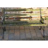Garden bench with cast iron ends in need of renovation