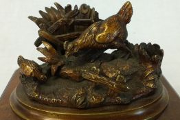 Small bronze decorative pen stand with chickens on naturalistic base on mahogany stand 11cm wide