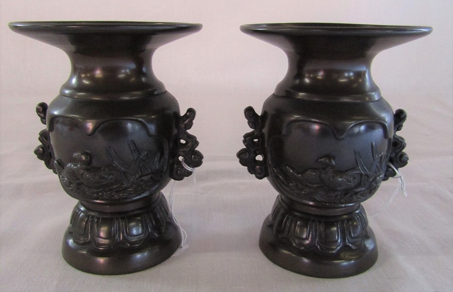 Pair of late 19th century Japanese bronze twin handled urns depicting nesting birds H 12.5 cm