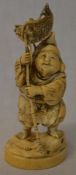 Meiji period carved ivory okimono depicting a fisherman with carp above his head Ht 13cm