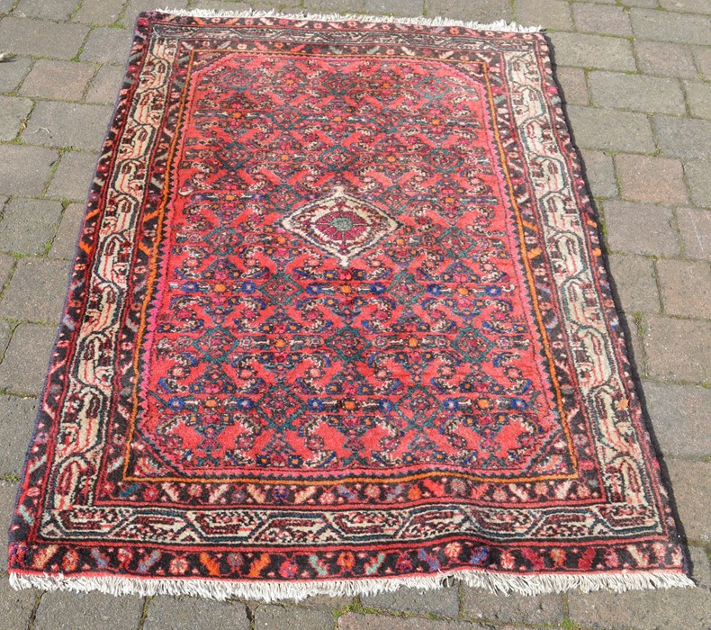 Red ground Middle Eastern rug 153cm by 104cm