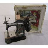 Early 20th century German tin plate child's sewing machine complete with instructions, clamp and