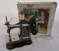 Early 20th century German tin plate child's sewing machine complete with instructions, clamp and