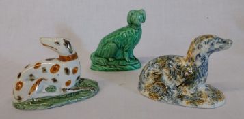 2 pearlware recumbent dogs, each approx. 10cm wide and 1 green sitting dog 9cm (some damage, chips