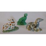 2 pearlware recumbent dogs, each approx. 10cm wide and 1 green sitting dog 9cm (some damage, chips