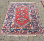 Red & blue ground Middle Eastern rug 188cm by 120cm