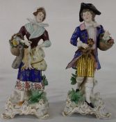 Pair of Samson type porcelain figurines dressed in eighteenth century costume on moulded rococo