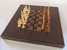 Late 19th century folding chess & backgammon board with Oriental chess pieces
