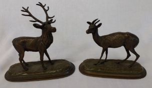 A pair of bronze animal figures, Stag and Hind on stepped oval bases signed A Leonard