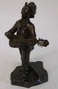 After D Alonzo - brown patinated bronze figure of a man playing a guitar stood on cobbles 26cm high