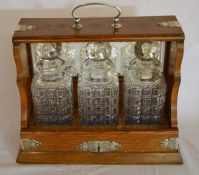 Late 19th/early 20th century oak tantalus with silver plate mounts