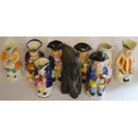 8 character jugs including Punch & Judy some repaired & a carved wood African tribal figure