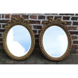 Pair of gilt oval wall mirrors