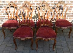 Set of 6 Victorian walnut balloon back chairs with ornate floral carved crest rail on cabriole legs