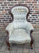 Ornately carved Victorian mahogany button back arm chair