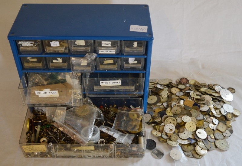 Small cabinet containing some watch parts & tools & a large quantity of watch dials