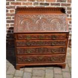 Georgian oak bureau with later carving on bracket feet