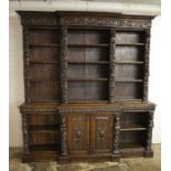 Large heavily carved oak late Victorian break front bookcase H 230 cm W 215 cm