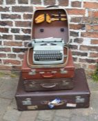 3 vintage suitcases and a portable typewriter