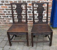 Pair of dark oak carved dining chairs
