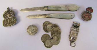 2 mother of pearl and silver fruit knives, silver three pence pieces, whistle and assorted badges