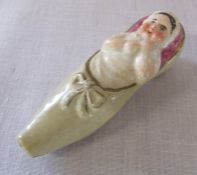 Novelty ceramic whistle in the form of a baby in a shoe L 7.5 cm