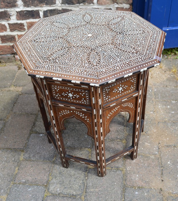 Eastern inlaid octagonal table on a folding base & inlaid with mahogany & ivory