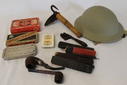 Selection of cut throat razors, 1954 army helmet, pig scraper, American spanner etc.