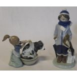 2 Lladro figurines - boy with dog and umbrella and girl washing dog