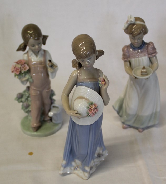 3 Lladro figurines -  girl with bird and flowers, girl with cake and girl with sun hat