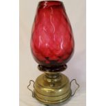 Brass paraffin lamp with large cranberry glass shade (damage to rim)