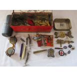 Tins containing various items inc Lincolnshire badges, miniature silver photo frame, glasses, pen