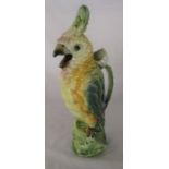 Continental ceramic jug in the form of a parrot, the handle a flower stalk H 35 cm