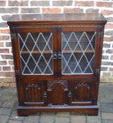 Small oak display cabinet with leaded glass & linen fold panels