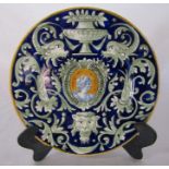 19th century maiolica circular plate, decorated with central portrait cartouche on a cobalt blue