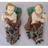 Pair of majolica wall pockets in the form of a merboy (some restoration to backs)