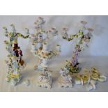 6 early 20th century porcelain figural candelabra with varying amounts of damage