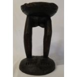 African carved wooden stool with dished circular seat on lady's legs and feet height 37cm,
