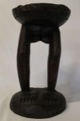 African carved wooden stool with dished circular seat on lady's legs and feet height 37cm,