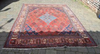Persian style carpet on red ground 310 cm x 220 cm