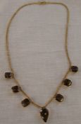 Tested as 9ct gold smokey quartz necklace, total weight 22.8g