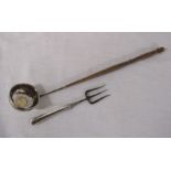 Silver handled toasting fork Sheffield hallmark & a white metal ladle with coin