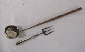 Silver handled toasting fork Sheffield hallmark & a white metal ladle with coin