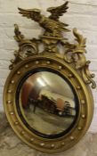 Regency style gilt framed convex wall mirror surmounted by an eagle