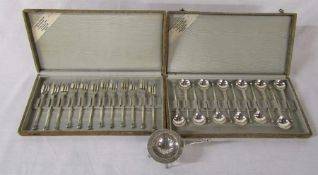 2 cased sets of 12 Dutch silver teaspoons and cake forks and a white metal tea strainer (weight